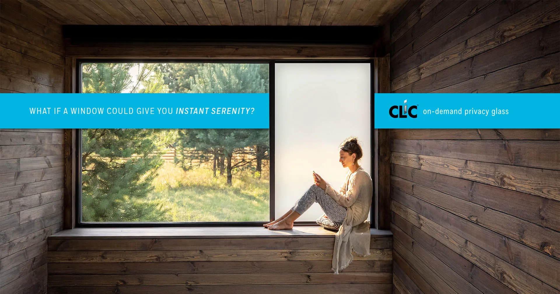 Woman reading by window with CLiC glass in wooden cabin — what if a window could give you instant serenity?